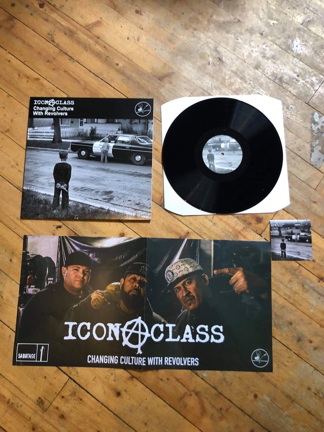 iconAclass Changing Culture with Revolvers vinyl record black Poster and Sticker